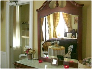 A bathroom with a vanity, a mirror, and a toilet.