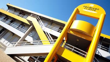A yellow and white building with a sign reading "Premiere Classe Hotels".