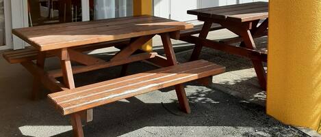 A picnic table set up outdoors with a building in the background.