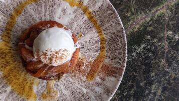 A dessert on a plate with a rustic design, placed on a textured surface.
