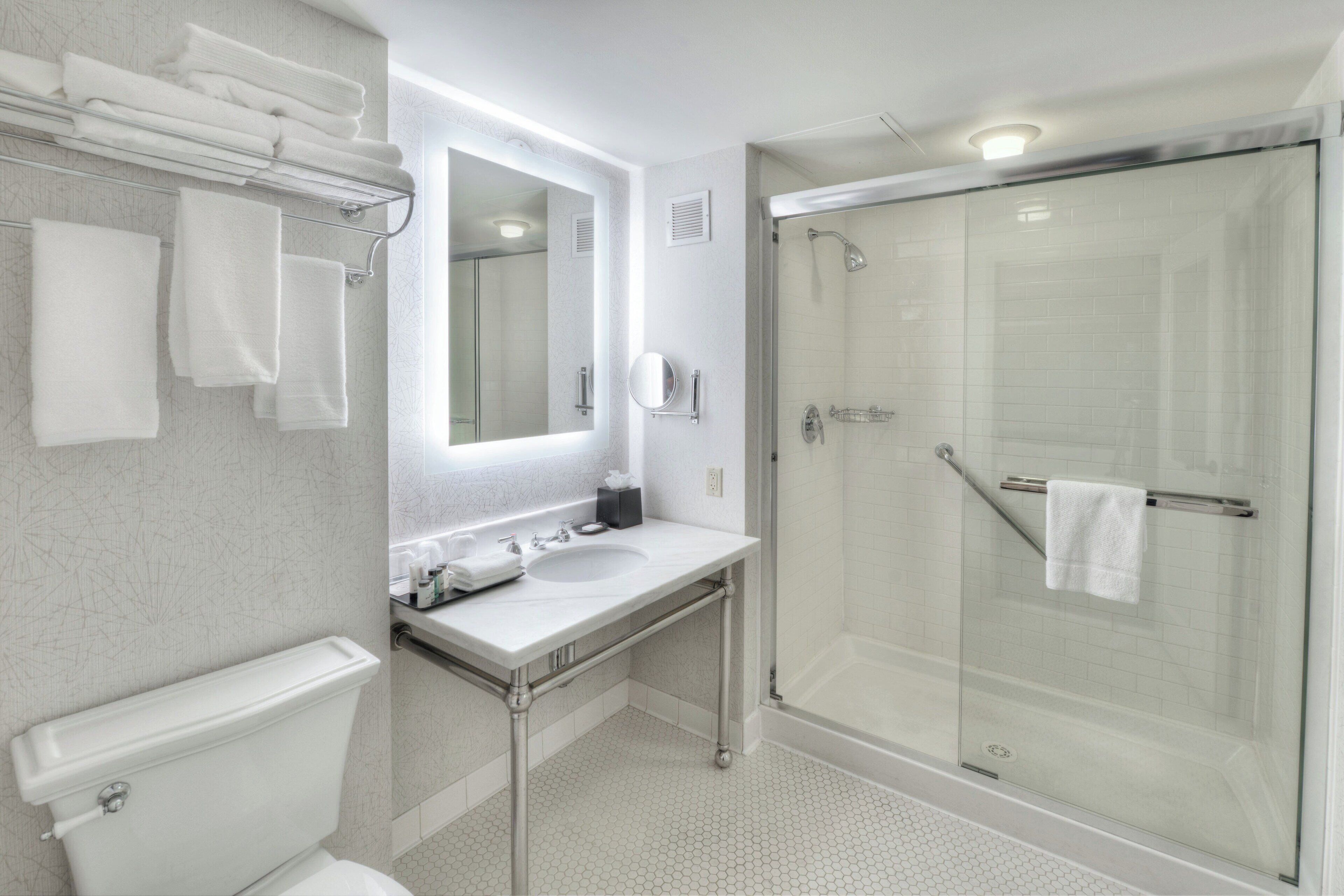 combined shower/bathtub, designer toiletries, hair dryer, towels