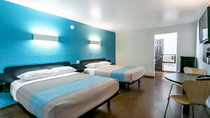 A hotel room with two beds, a desk, and a chair. - Motel 6 University Missoula (Missoula)