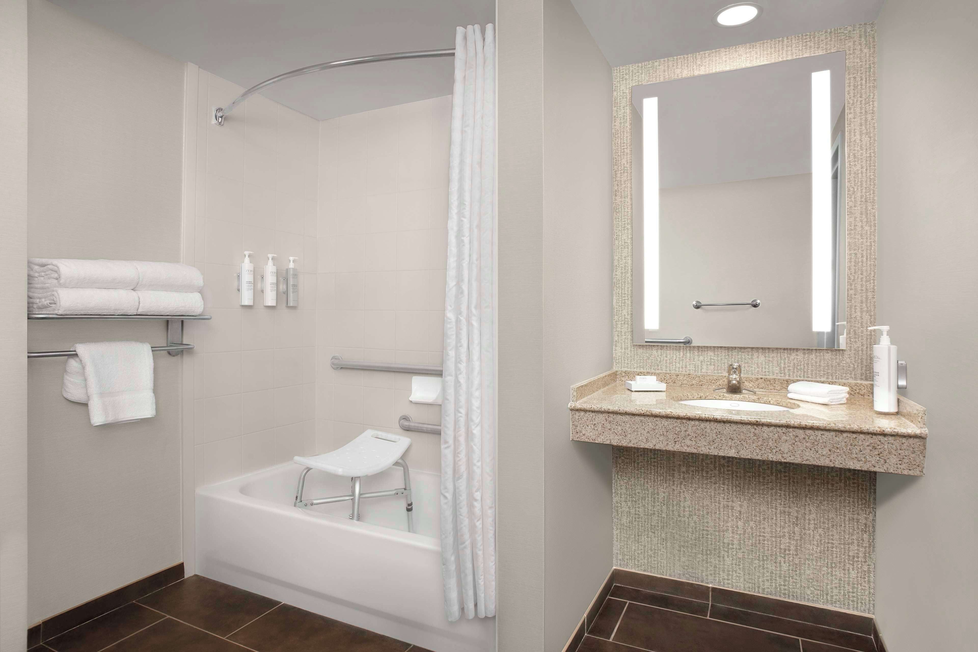 combined shower/bathtub, designer toiletries, hair dryer, towels