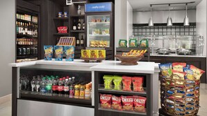 A grocery store interior with shelves stocked with snacks, beverages, and packaged goods. - Hilton Garden Inn Gainesville (Gainesville)