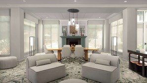 A modern dining area with a wooden table, four chairs, and a fireplace. - Hilton Garden Inn Gainesville (Gainesville)