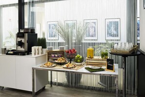 A breakfast buffet setup with various food items and a coffee machine. - Park Inn by Radisson Liege Airport (Grace-Hollogne)