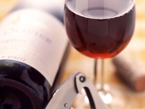 A wine bottle and a wine glass with a corkscrew. - ibis Bordeaux Centre Bastide (Bordeaux)