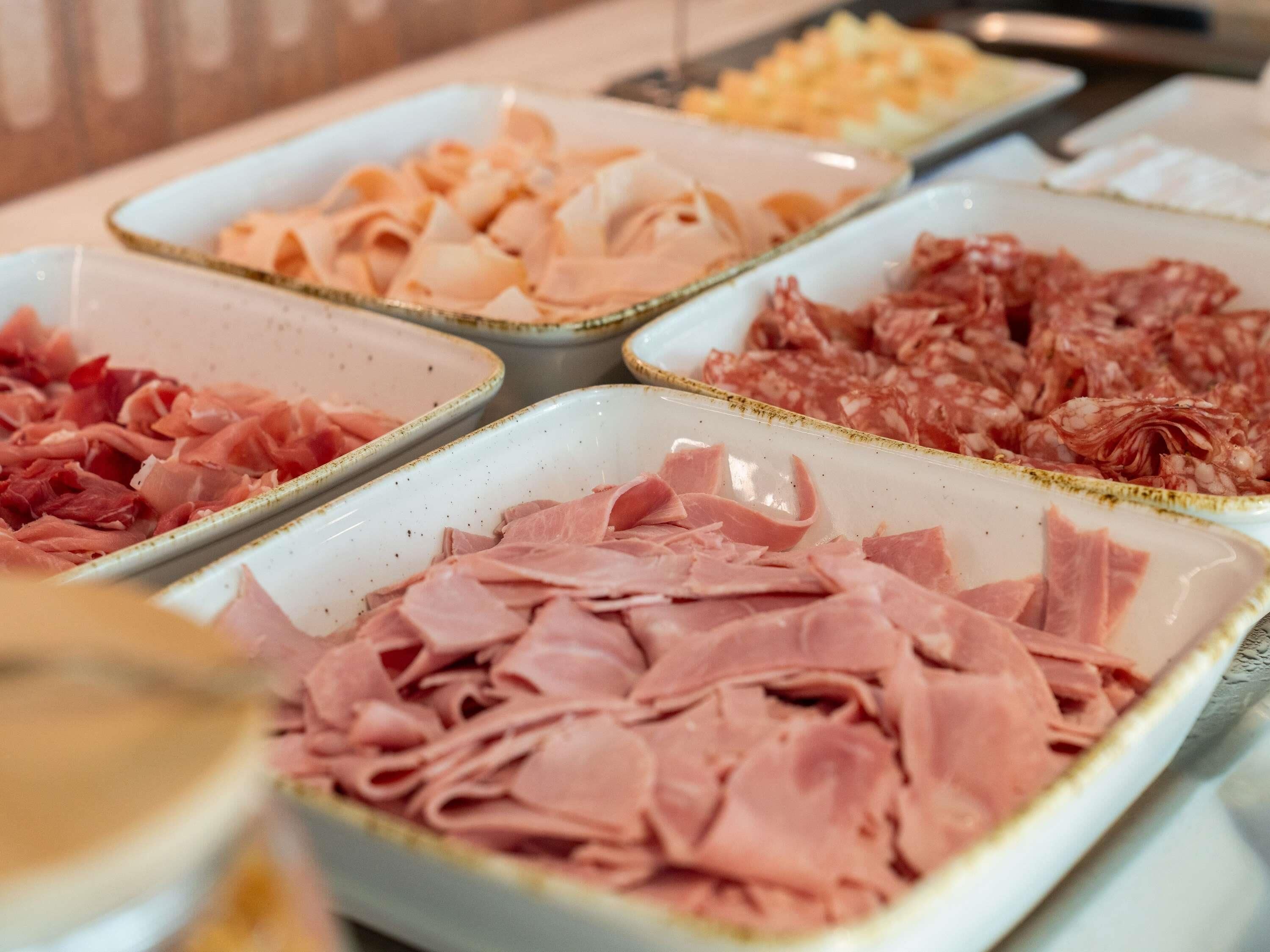 A buffet with various types of meats.
