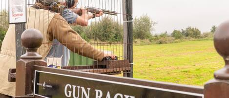 A gun rack with a sign reading "GUN RACK" and "MOUNT FALCON".