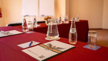 A conference table with documents, a pen, and glassware.