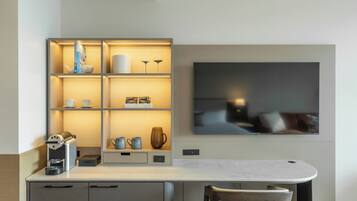 A modern kitchen with a built-in espresso machine, a coffee maker, and a coffee table.
