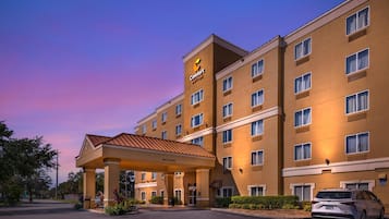 A Comfort Suites hotel with a covered entrance and multiple floors.