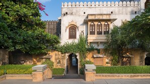 A historic building with a central arched entrance, a decorative balcony, and a traditional architectural style. - Rawla Narlai (Desuri)
