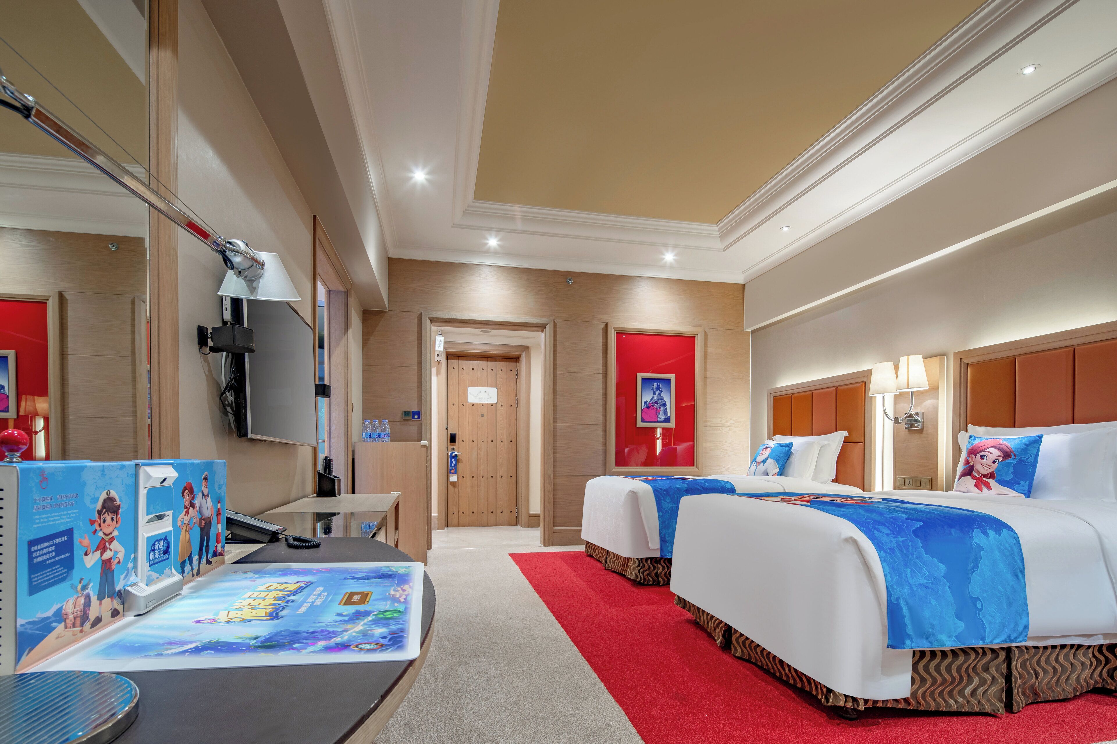 A hotel room with two beds, a desk, a TV, and a red carpet.