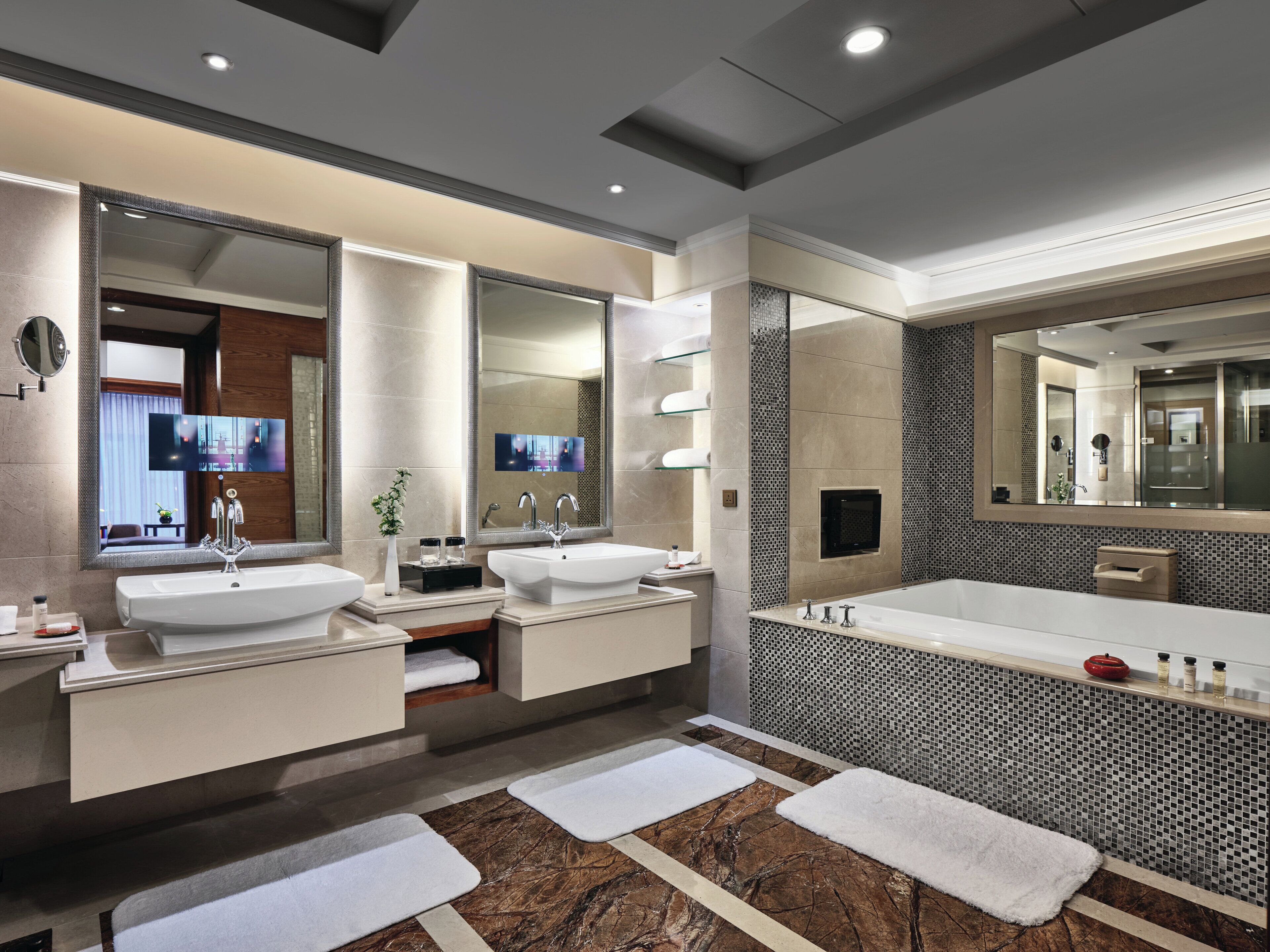 A modern bathroom with dual sinks, a large mirror, and a tiled floor.