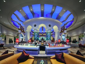 A lobby with a central bar area, seating arrangements, and a distinctive ceiling design. - InterContinental Shenzhen by IHG (Shenzhen)
