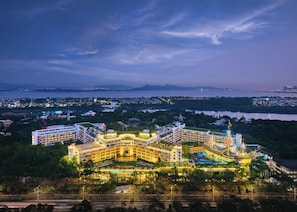 A large hotel with multiple buildings, a waterfront view, and a bridge in the background. - InterContinental Shenzhen by IHG (Shenzhen)