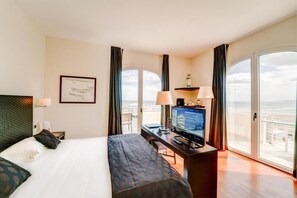 Relax in this stylish room with a large bed, desk, and city view.