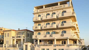 A multi-story building with balconies and a sign that reads 'Terrazza Marco'.