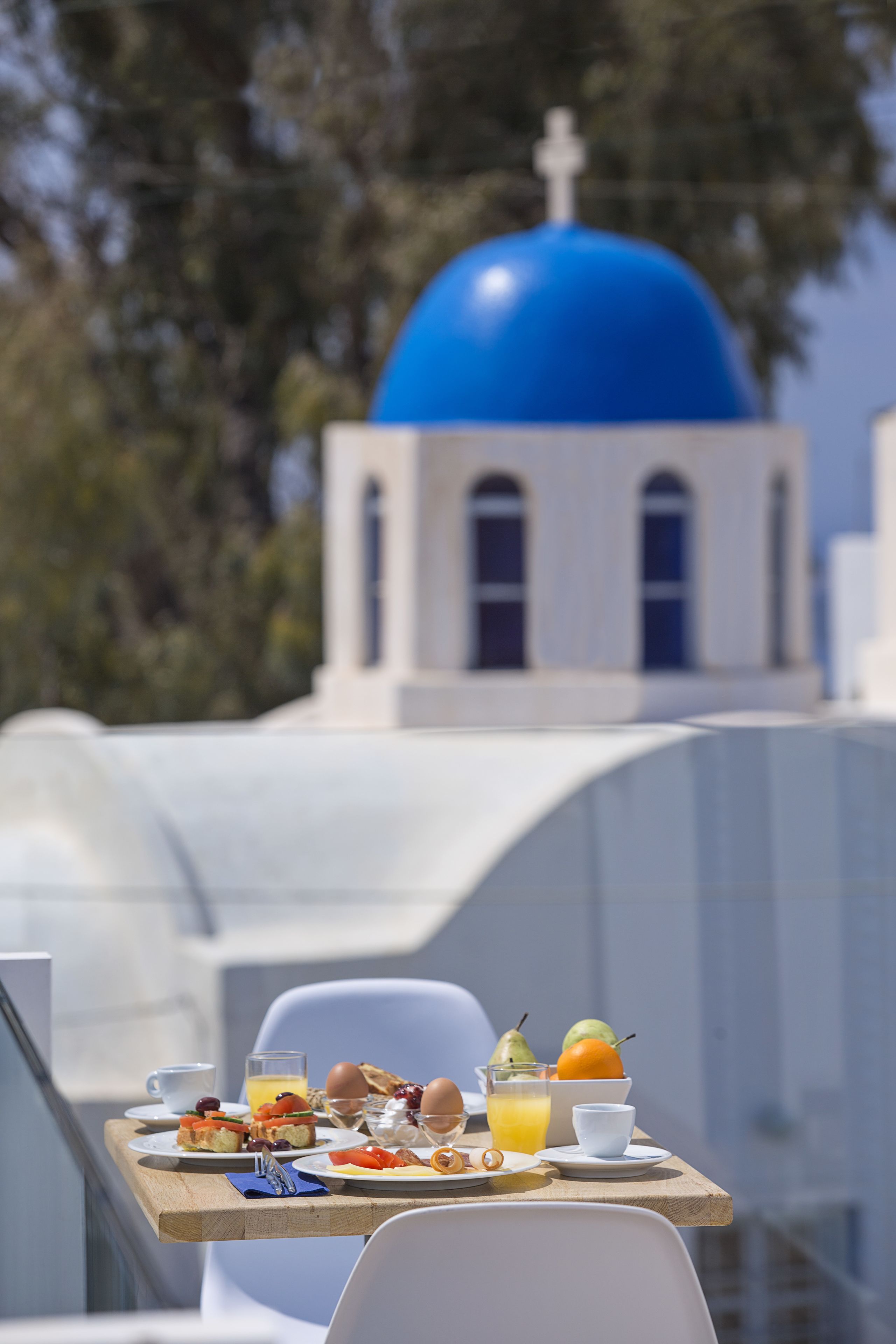 A breakfast table with a view of a blue-domed building in the background.