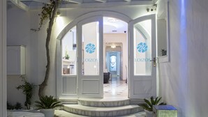 A hotel entrance with a marble staircase leading to a reception area. - Loizos Stylish Residences (Santorini)