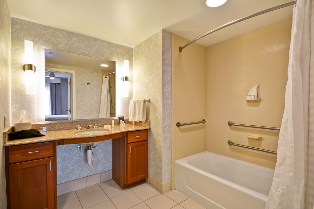 combined shower/bathtub, designer toiletries, hair dryer, towels