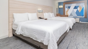 A hotel room with two beds, a wooden headboard, a geometric wall art piece, and a patterned carpet. - Holiday Inn Express Hotel & Suites San Diego Otay Mesa by IHG (San Diego)