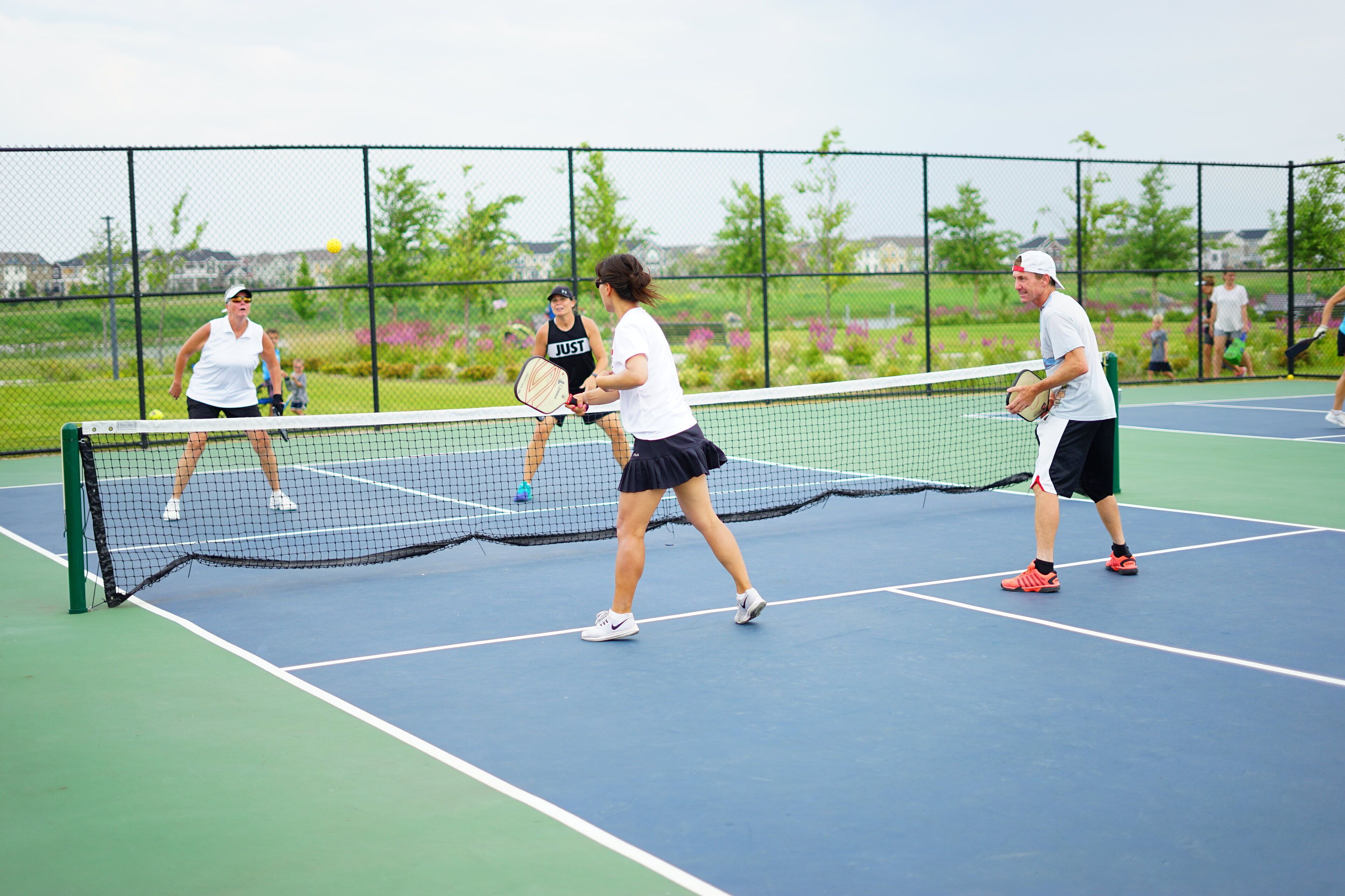 A tennis court with players in action.