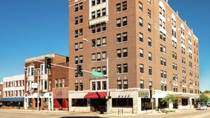 A multi-story brick building with a prominent sign reading "Champion Hotel."