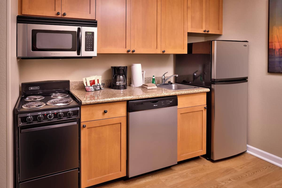 full-sized fridge, microwave, stovetop, dishwasher