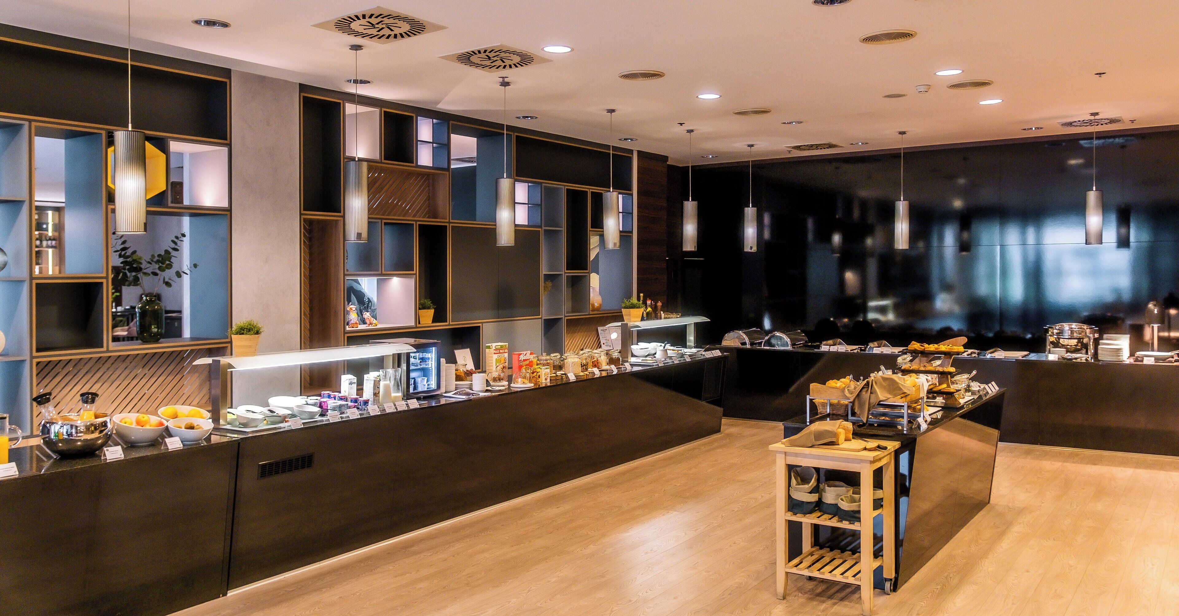 A modern breakfast bar with a variety of food items and a coffee station.