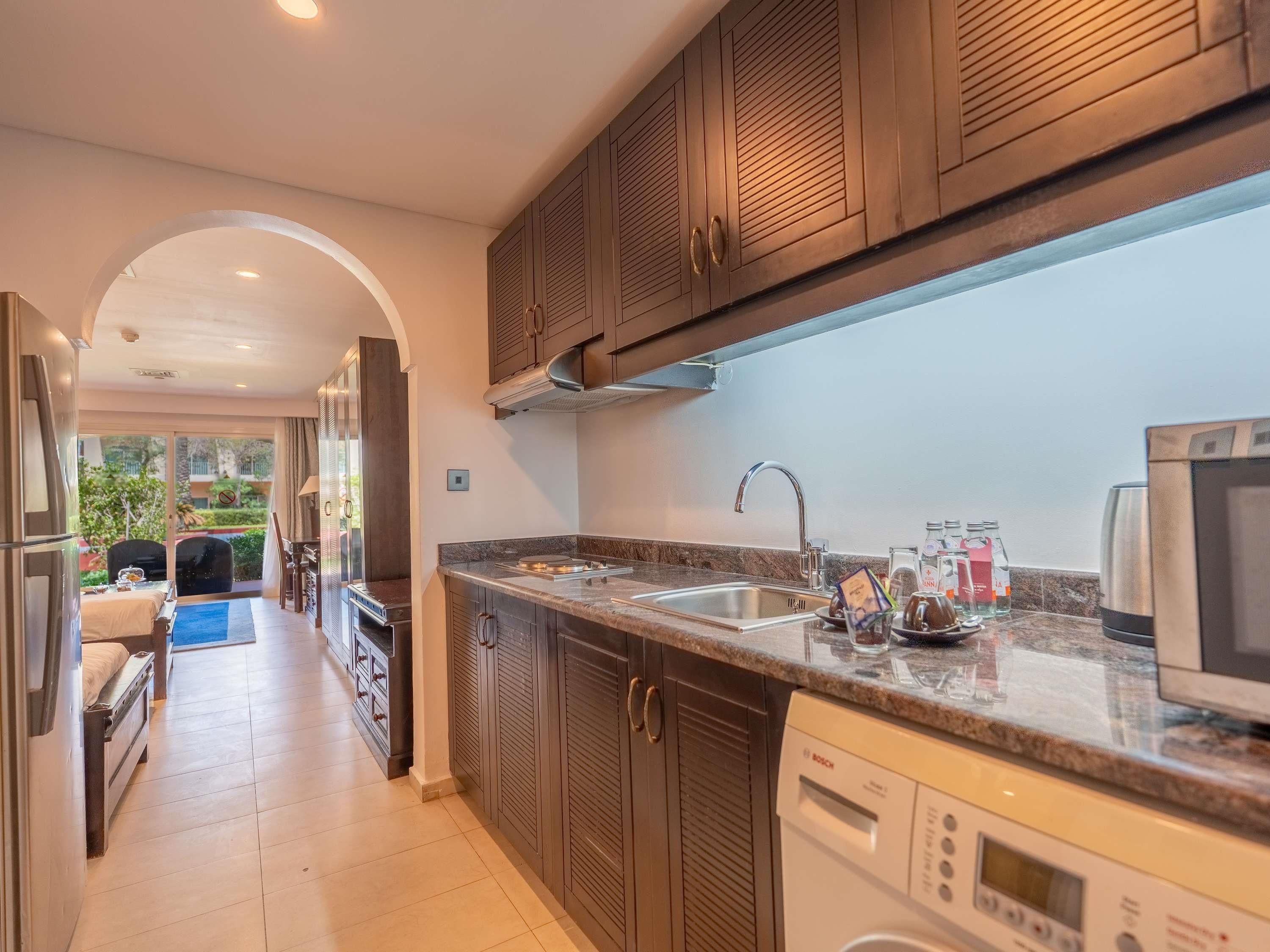 A modern kitchen with a Bosch dishwasher, a sink, and a stove.