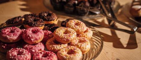A variety of donuts on a glass plate.