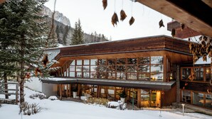 A modern wooden building with large windows and a covered outdoor area. - Sporthotel Teresa (Badia)