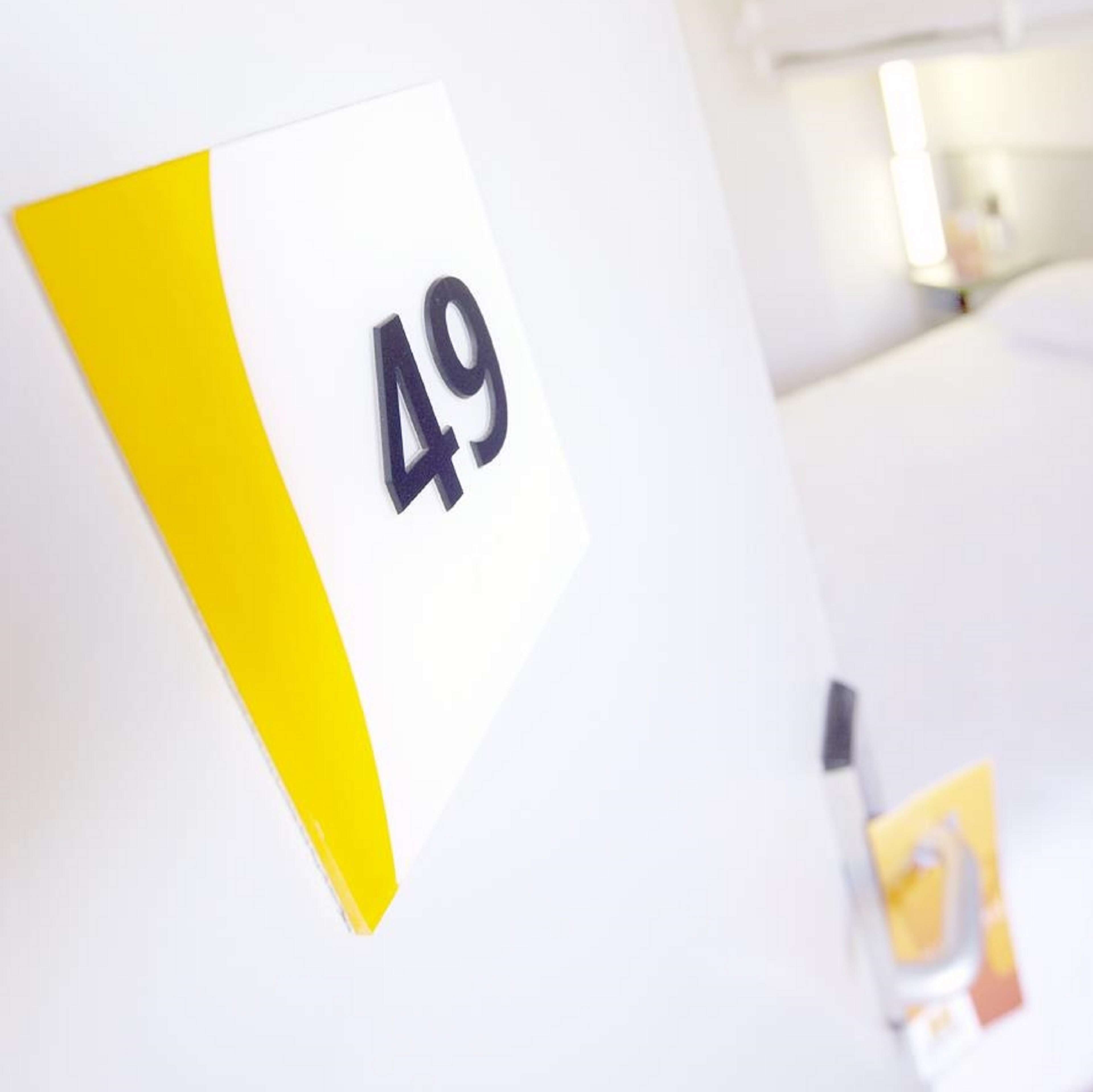 A room number sign with the number 49.