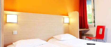 A hotel room with two beds, a red chair, and a window with curtains.