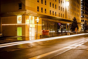 A hotel entrance with a modern design, including a large planter and a clear view of the street. - Premiere Classe Lyon Centre - Gare Part Dieu (Lyon)