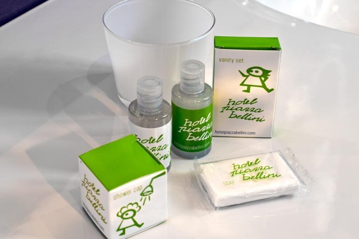 A vanity set including a soap bar, a shower gel bottle, a glass, and a box.