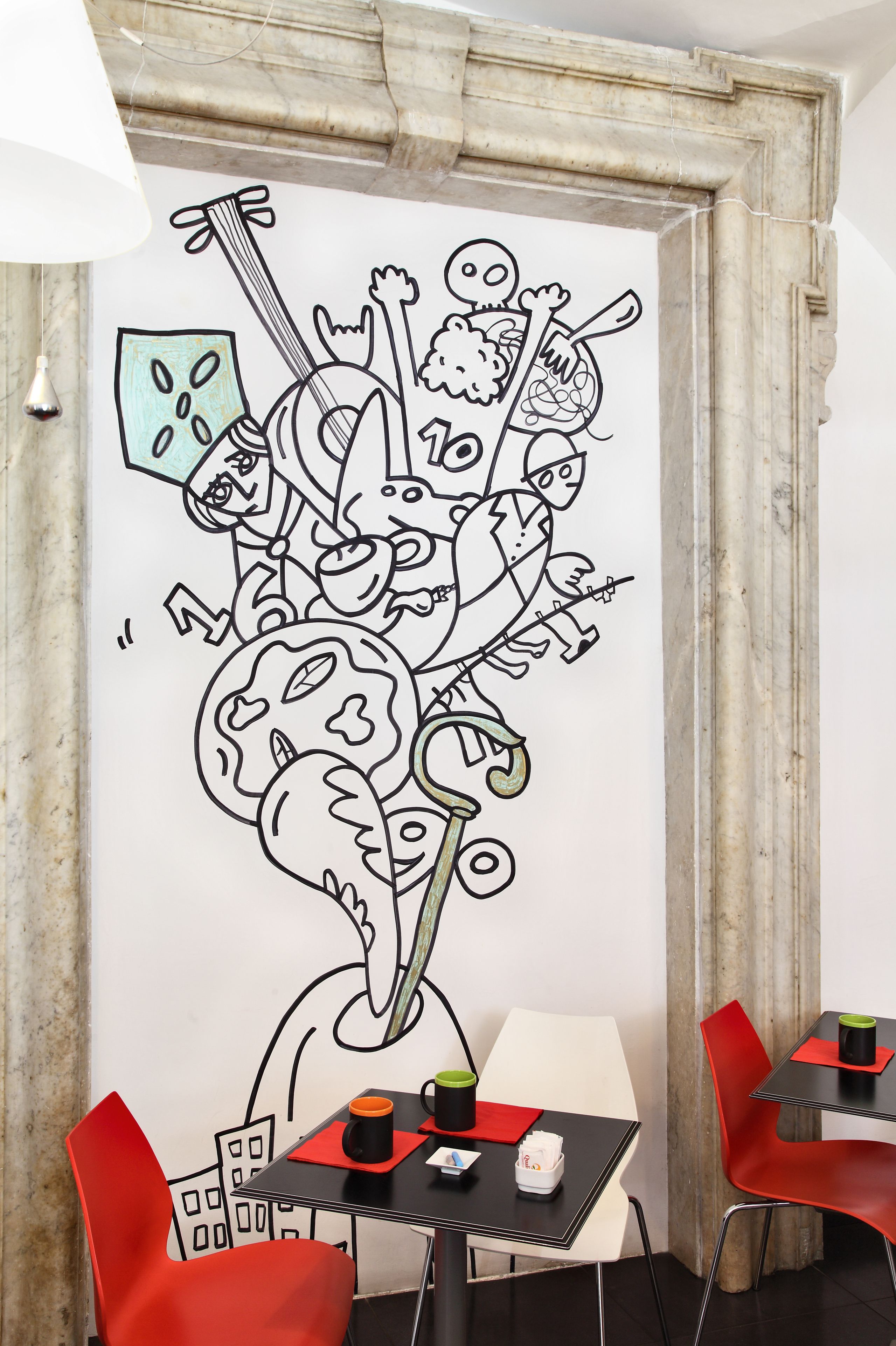A modern room with a large abstract wall art, a dining table with chairs, and a small table with a cup and a bag.