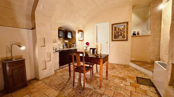 A cozy dining area with a table, chairs, and a lamp.