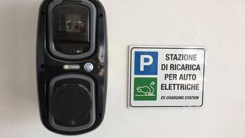 An electric vehicle charging station with a sign indicating it is a public charging station.