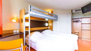 A bunk bed with a desk and chair, a TV, and a wardrobe with hangers.