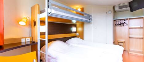 A bunk bed with a desk and chair, a TV, and a wardrobe with hangers.