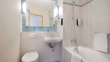 A bathroom with a toilet, sink, and bathtub.