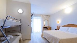 A hotel room with a bunk bed, a single bed, a desk with a chair, a mirror, and a nightstand. - Falco (Riccione)