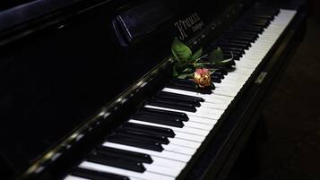 Ein Klavier mit einer Rose auf den Tasten.