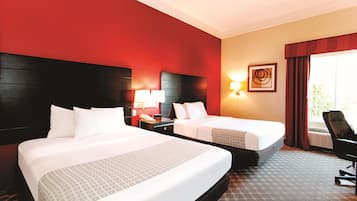 Premium bedding, desk, laptop workspace, blackout drapes