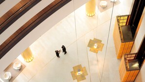 A multi-level interior with a modern design, featuring a central open space with seating and a staircase. - Hyatt Regency Kyiv (Kyiv)