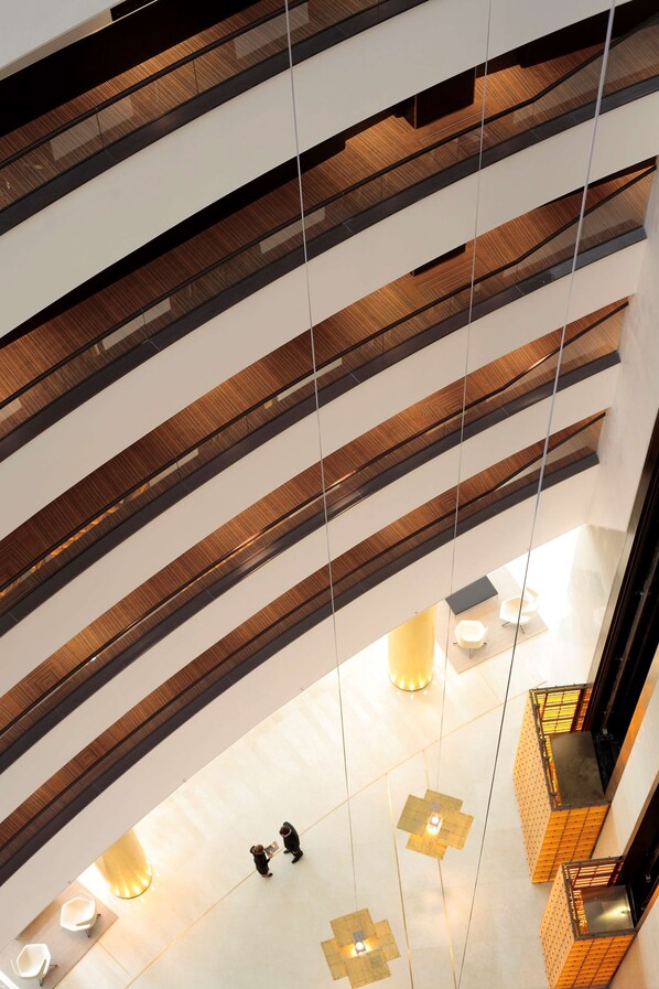 A multi-level interior with a modern design, featuring a central open space with seating and a staircase. - Hyatt Regency Kyiv (Kyiv)