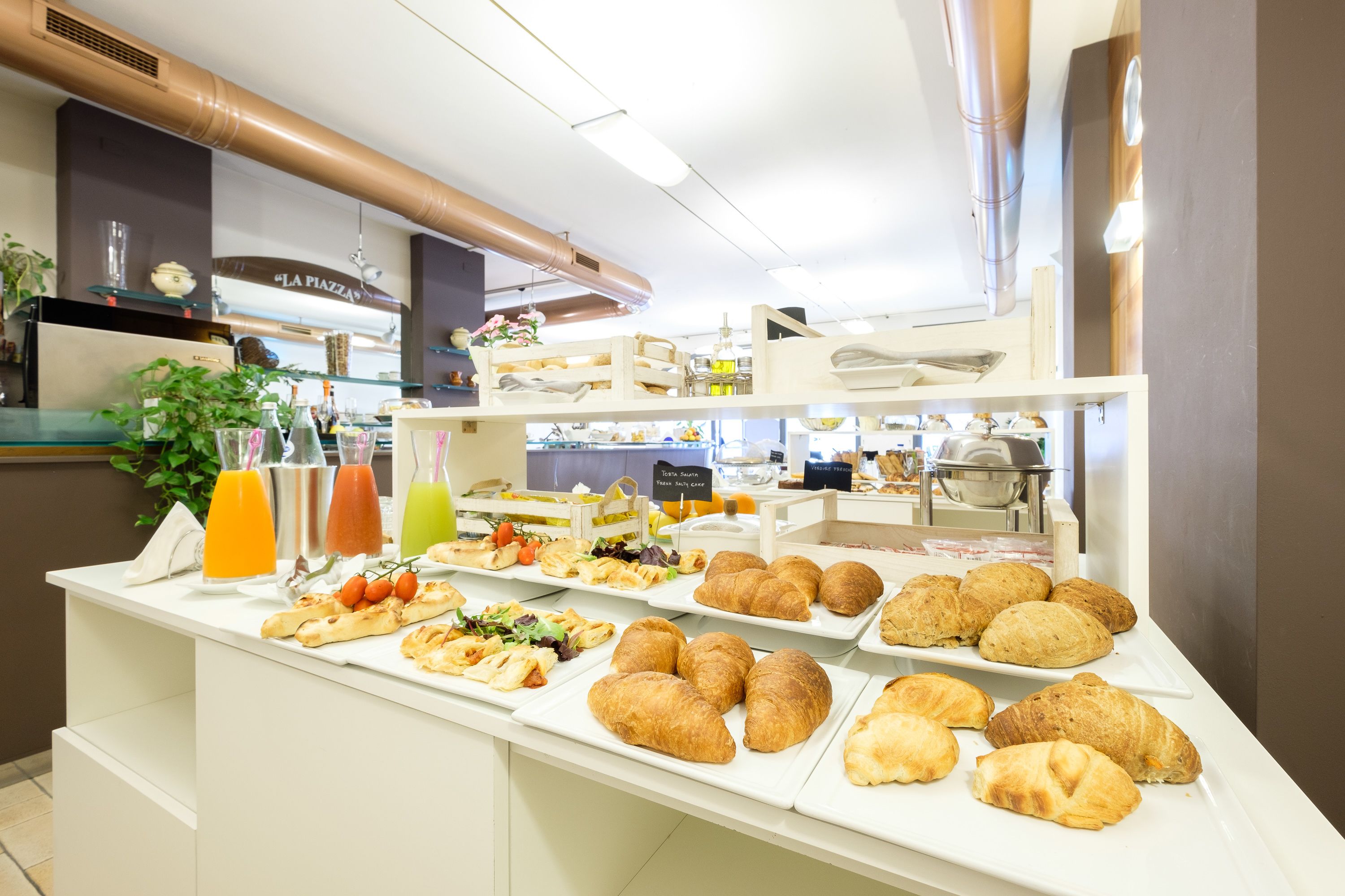 A buffet with various food items and drinks.